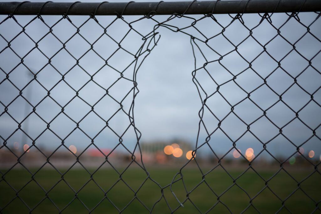 selective focus photography of gray metal fence